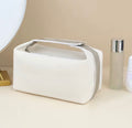 Krämvit makeup bag i canvas med öppningsbart bärhandtag och dragkedja från Natta Collection.